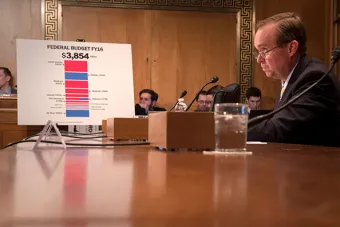 man sitting in front of budget chart