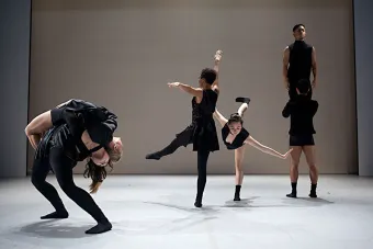 drt momentum in black dancers in front of white screen 