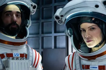 two astronauts in their gear looking at the camera