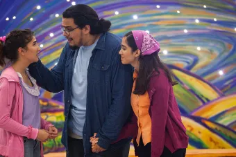family in front of rainbow swirl