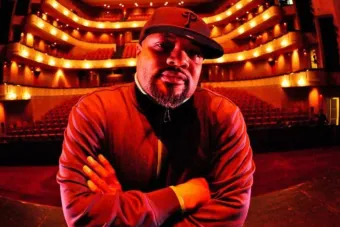 man standing in front of theatre seats