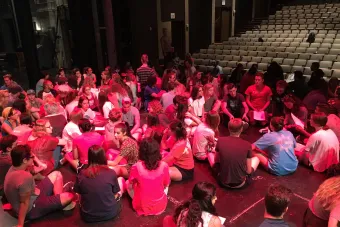 students sitting on a stage