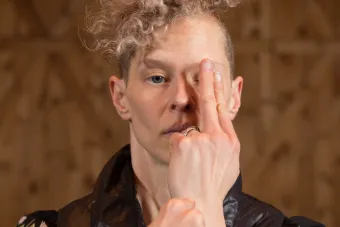 Dancer with hand in front of her face