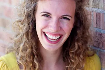 woman in yellow blouse smiling