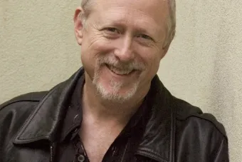 man in leather jacket smiling 