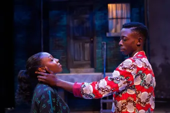 man caressing woman's ear