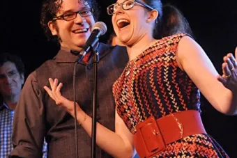 woman in plaid at microphone