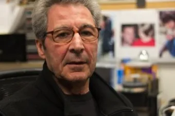 older man in office with many documents