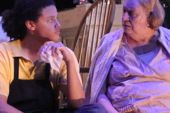 man and woman sitting next to and looking at each other