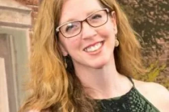 Woman with blond hair wearing glasses