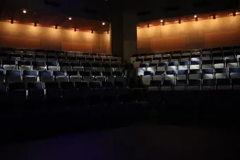 shadowed house seating in an empty blackbox theatre