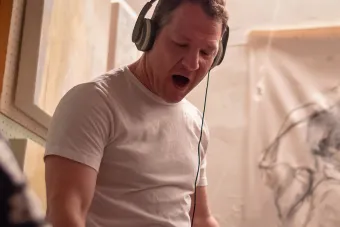 person in white t-shirt with headphones