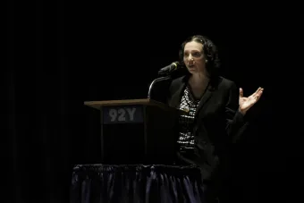 Rebecca Rossen at podium discussing NEH grant