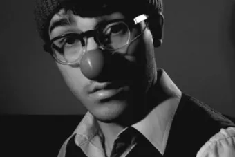 a portrait of robert didonato wearing a clown nose