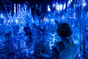 Two audience members sit in an immersive installation presented during The Cohen New Works Festival
