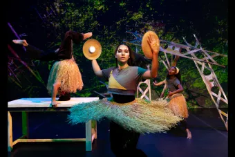 A woman in a grass skirt spinning