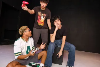 Photo of three male actors casually dressed in coversation