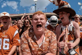 Acting major Preston Powe cheers enthusiastically at a Texas Longhorns football game