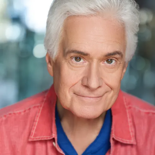 Headshot of Lucien Douglas with a red jacket 