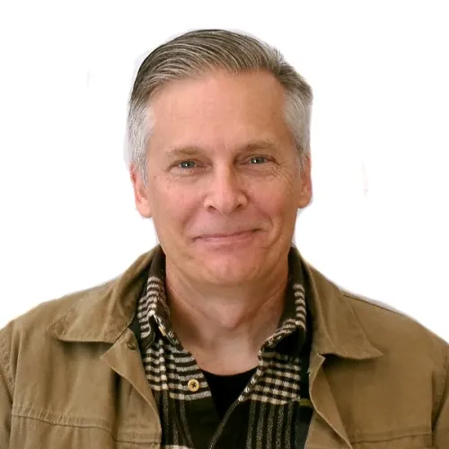 Headshot of Rusty Cloyes in a brown jacket