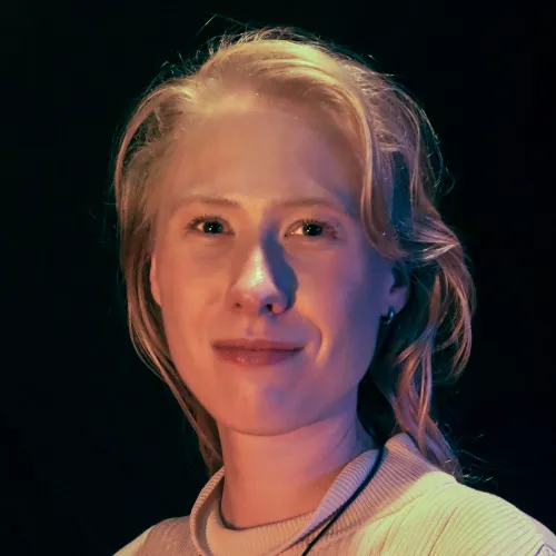 A woman with long blonde hair looks forward