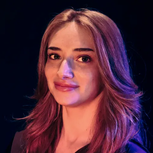 A woman with long red hair smiles