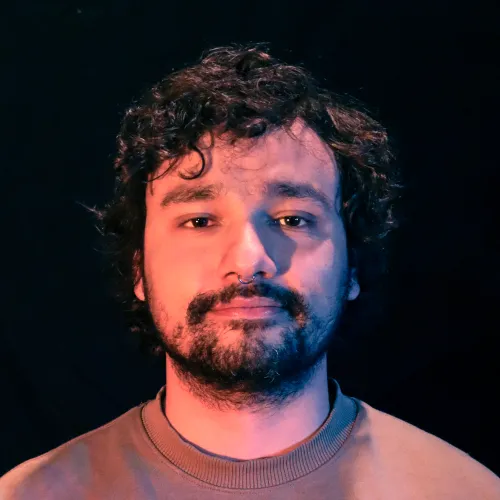 A man with short curly hair and a beard