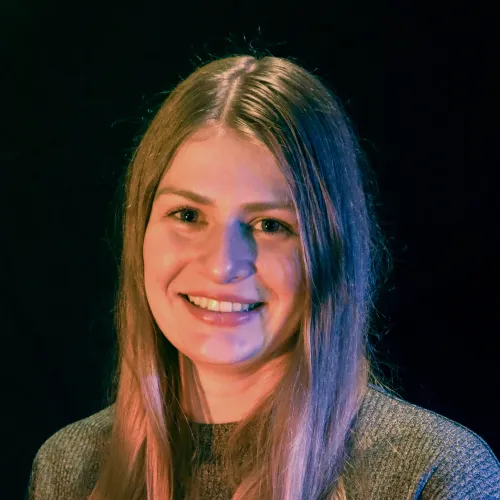 A woman with long blonde hair smiles