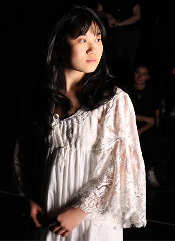 OUR TOWN actor Mia Nguyen looks to her left