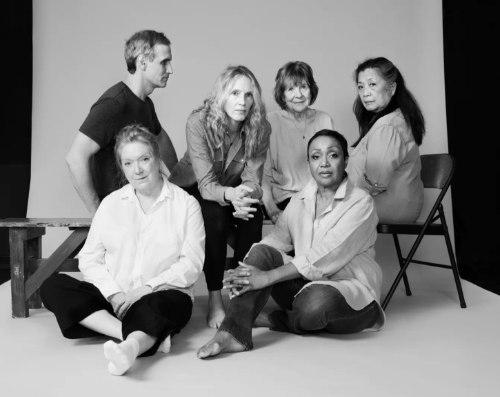 Five women in the cast of Annie Baker's INFINITE LIFE sit, looking directly at the camera, while a sixth cast member looks at them