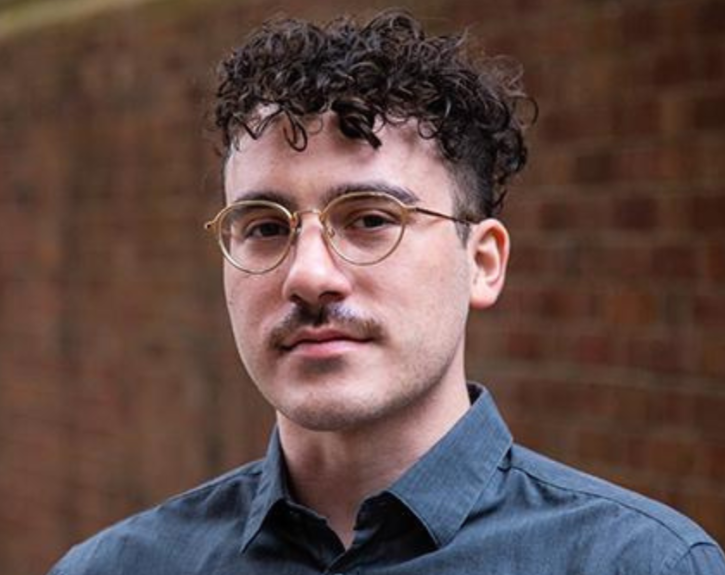 Roberto Di Donato is named the new Producing Director of the Tantrum Theater, and is pictured here looking into the camera against a brick wall.