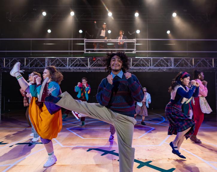 An ensemble of actors perform an upbeat jazzercise routine in A BEAUTIFUL DAY IN NOVEMBER ON THE BANKS OF THE GREATEST OF THE GREAT LAKES