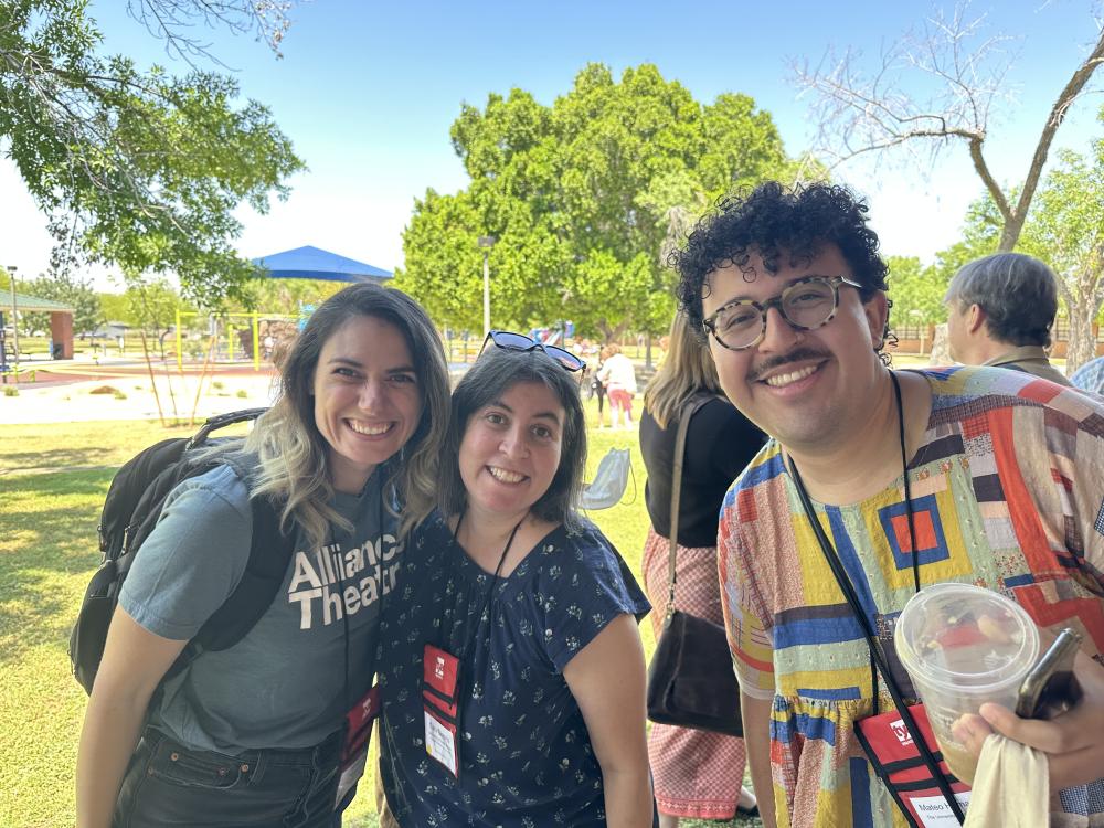 Alum Sam Provenzano, faculty member Sara Simons and grad student Mateo Hernandez pose together in front of trees and a bright blue sky