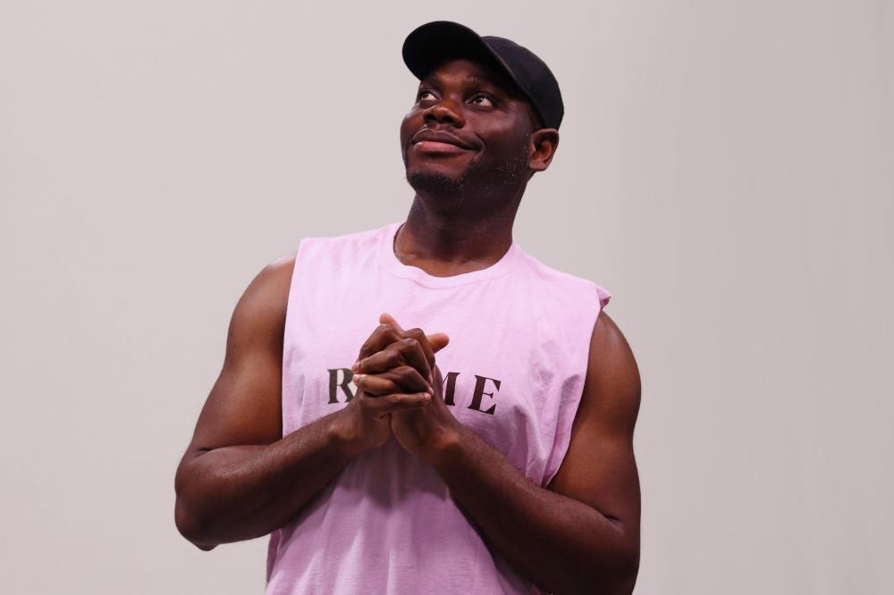 Sinclair Photo in pink tank looking up 