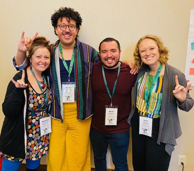 Roxanne Schroeder-Arce, Mateo Hernandez, Martin Rodriguez and Lara Dossett pose together, holding their hands up in a Hook 'em Horns symbol