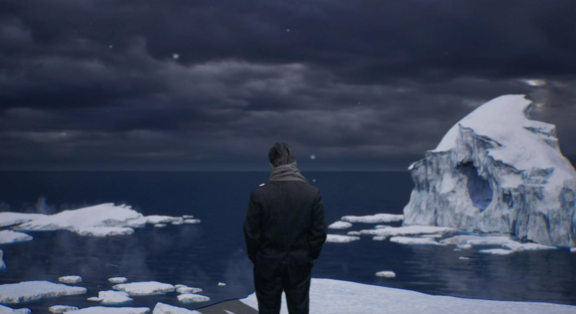 the back of a man in a black suit top and pants looking out over an icy ocean
