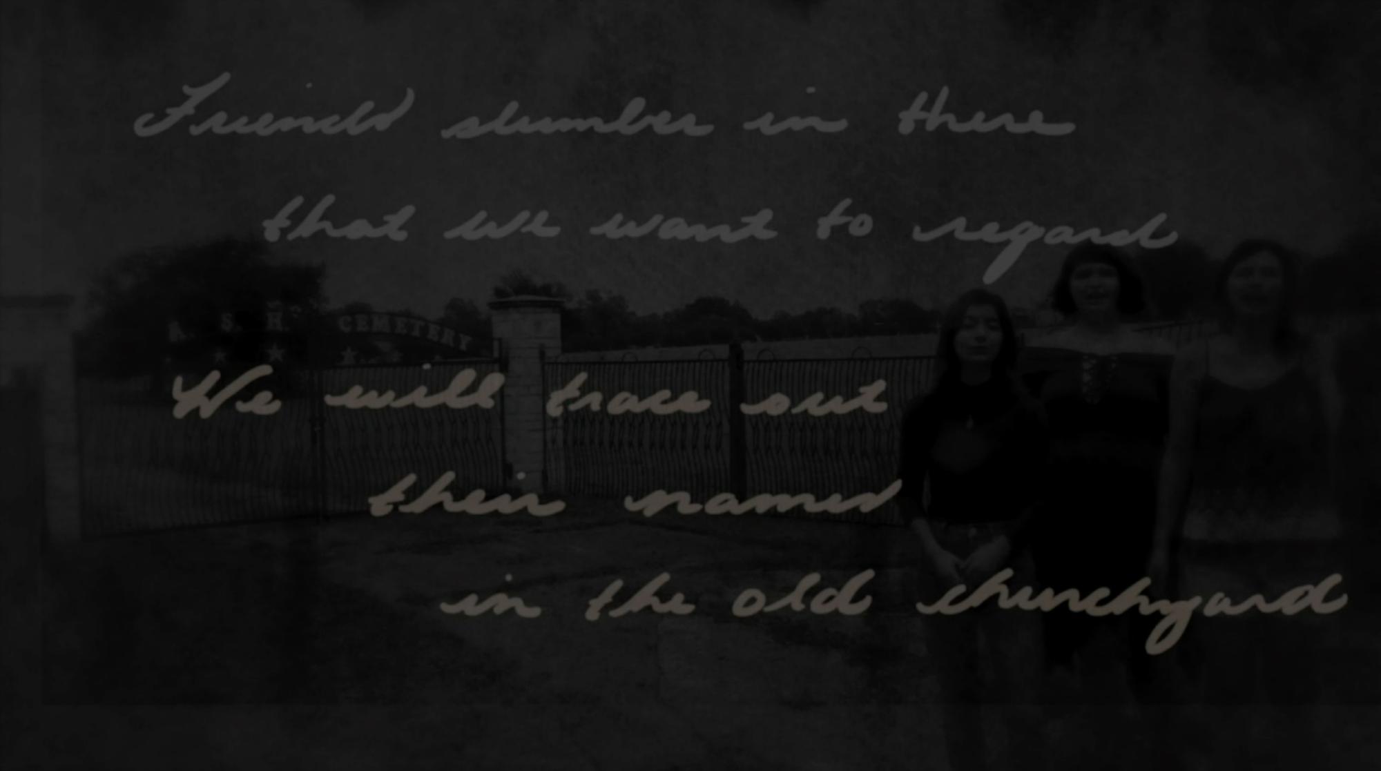 a darkened image of three ensemble members standing in front of a gate, with the words "Friends slumber in there that we want to regard. We will trace out their names in the old churchyard."