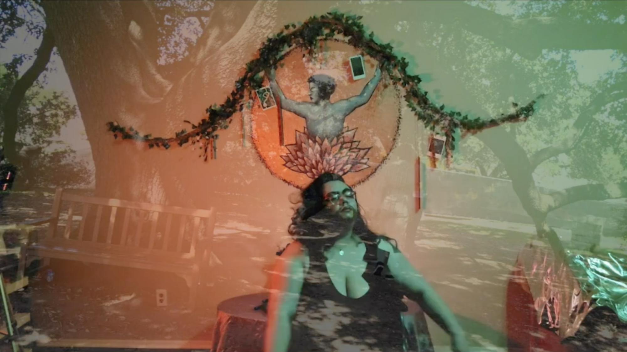 an ensemble member sits in front of a decorative memorial, with the outline of trees placed over the image