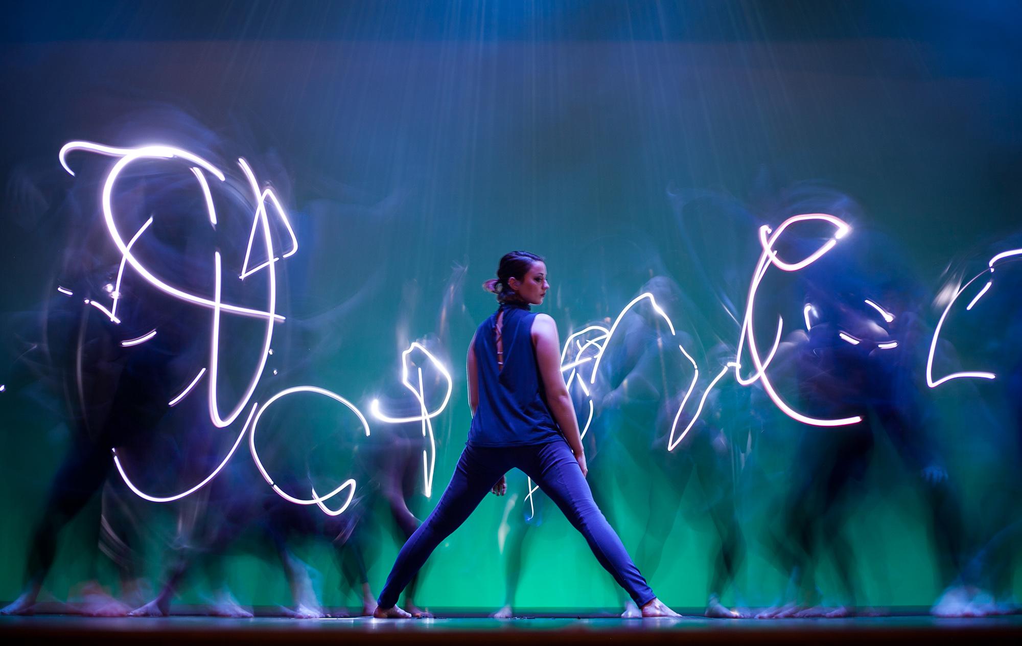 dancer surrounded by moving lights