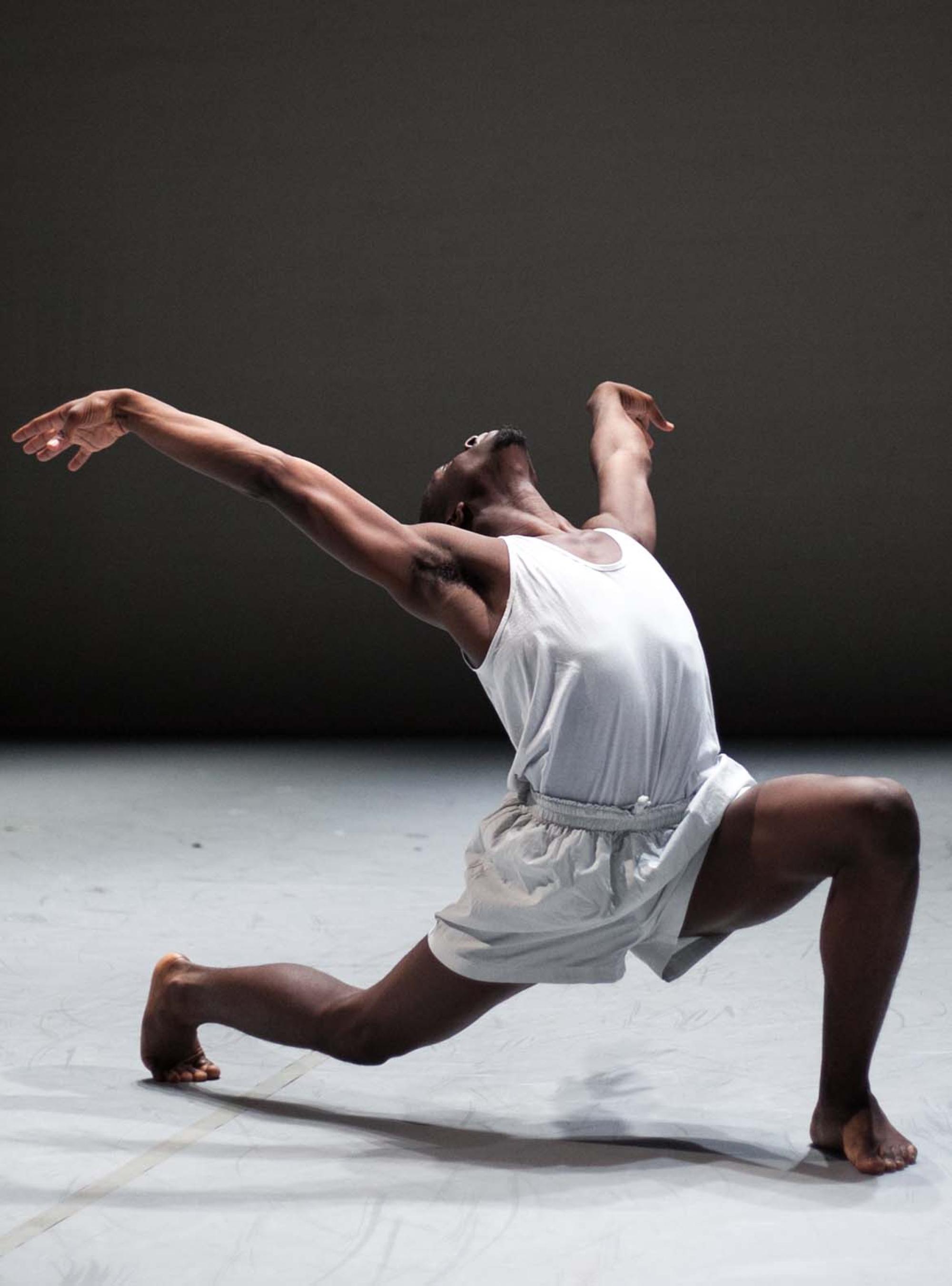 dancer leaning back in all white