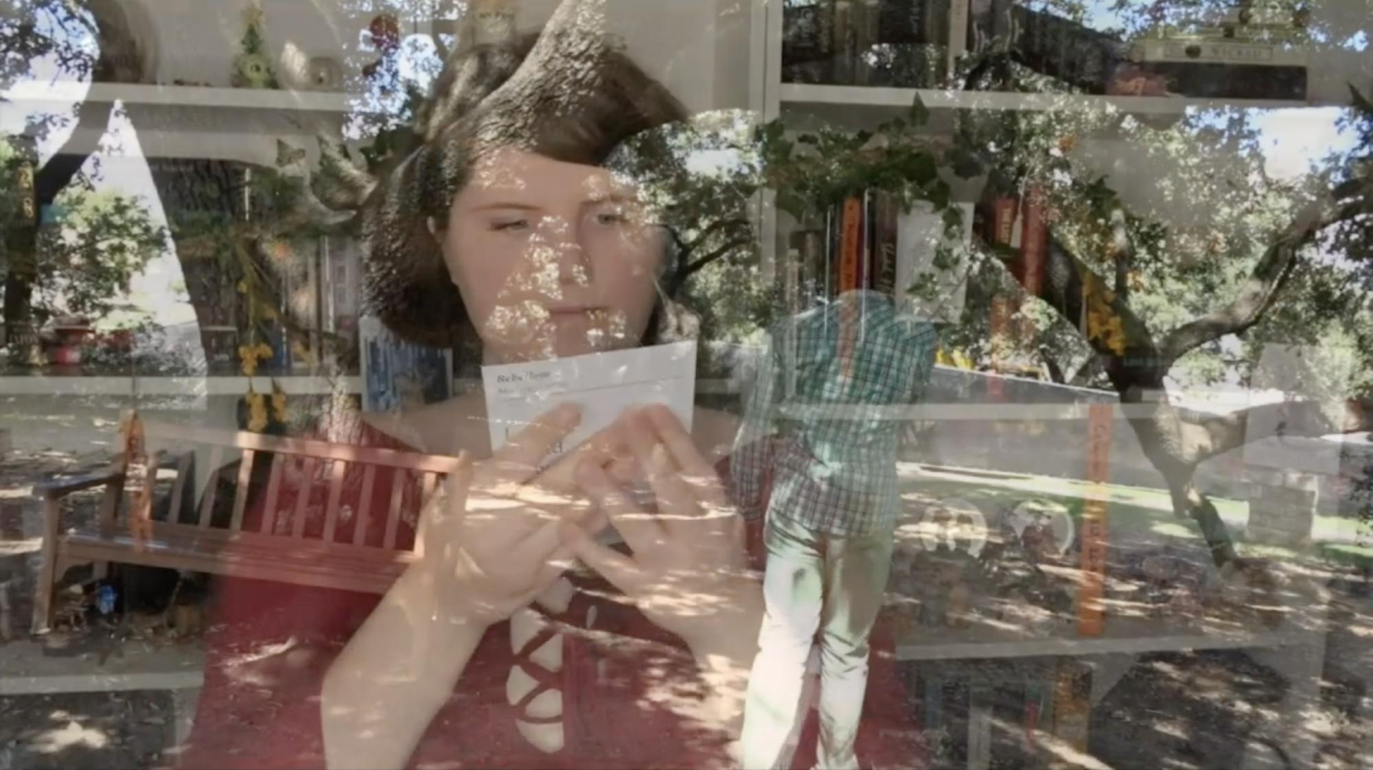 two images layered over each other - one of an ensemble member looking at a piece of paper, the other of an ensemble member standing in front of a tree