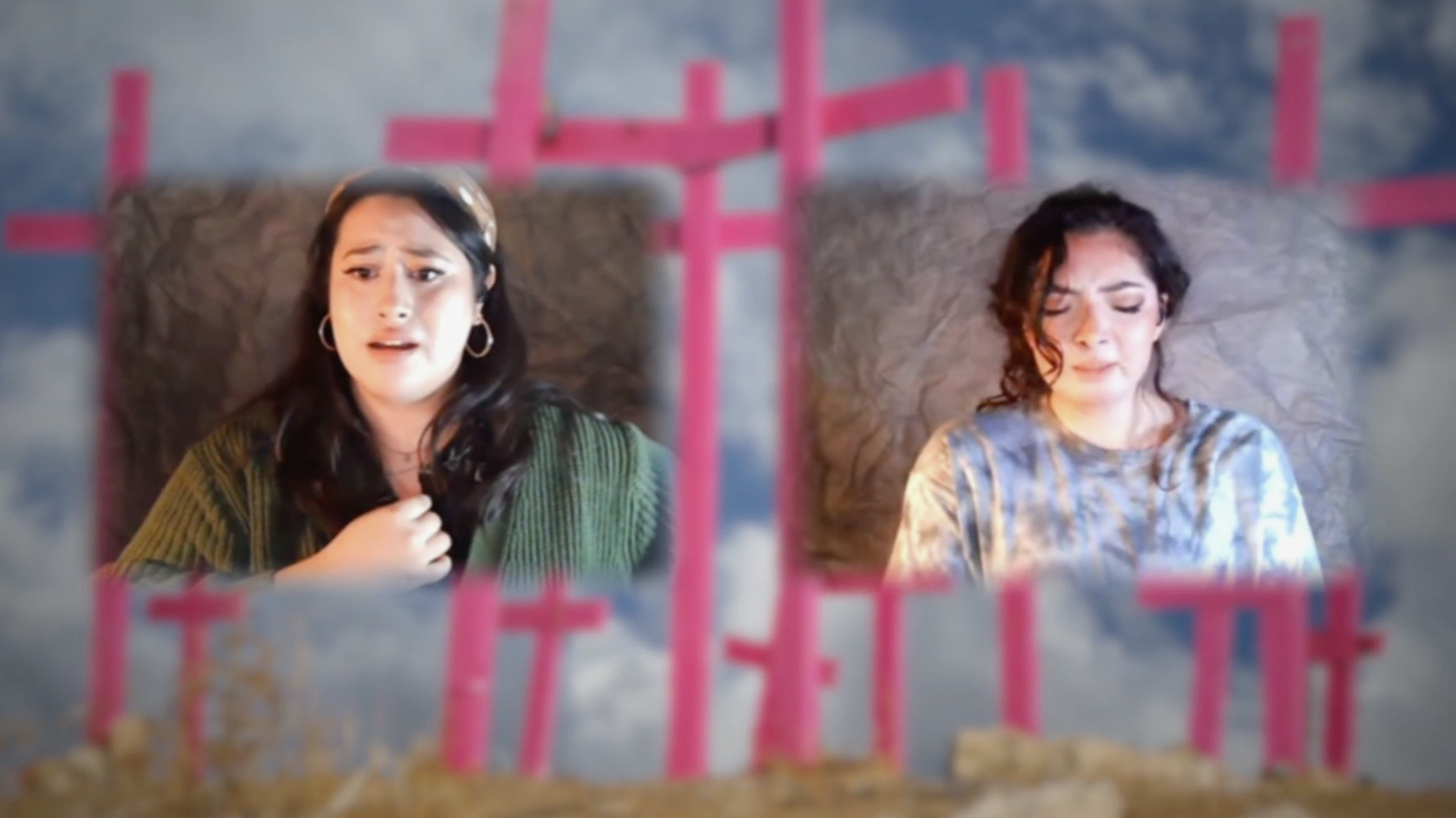 two actresses hold back tears, performing remotely with pink crosses in the background