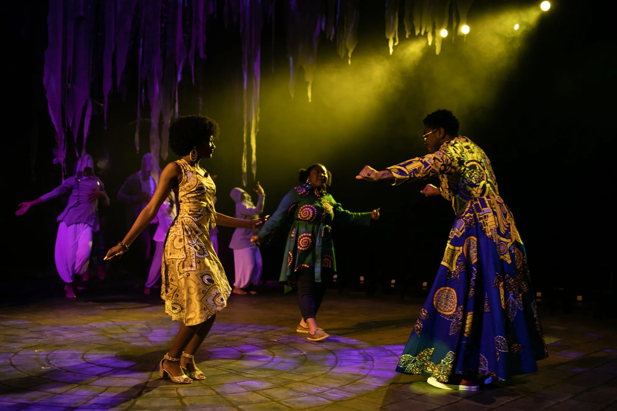 actor and actresses dance with ensemble in the background