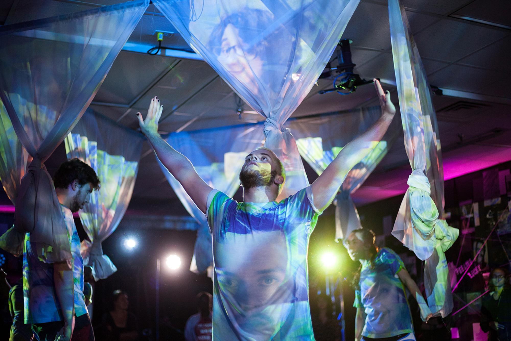 group of people standing among projections