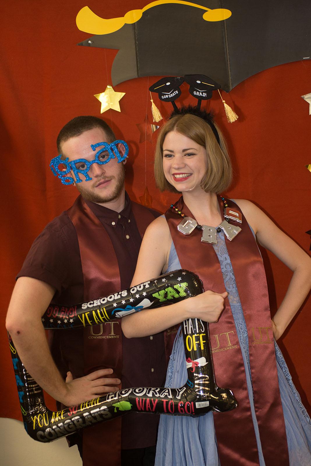 two people dressed in graduation clothing