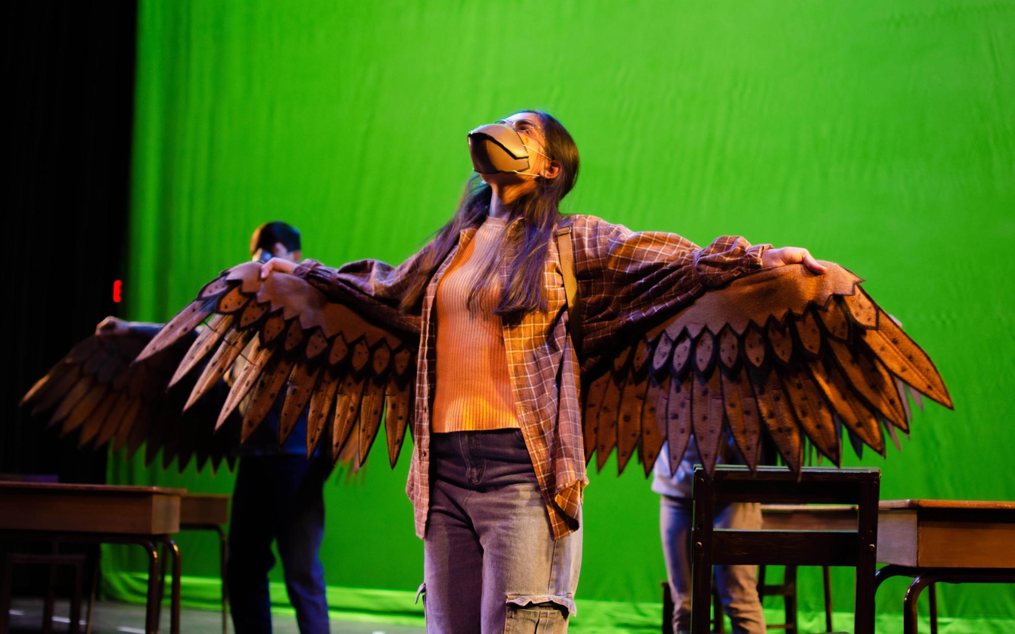 actress wearing detailed wings made out of leather and a bird beak