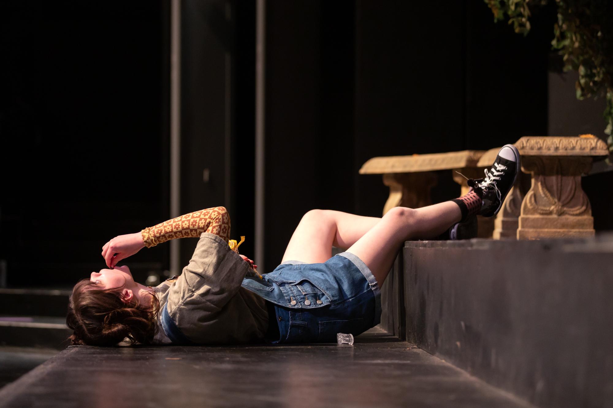 Penny Lou Zimmerman as Clara lays down, relaxing, before her father, Arthur, comes home.