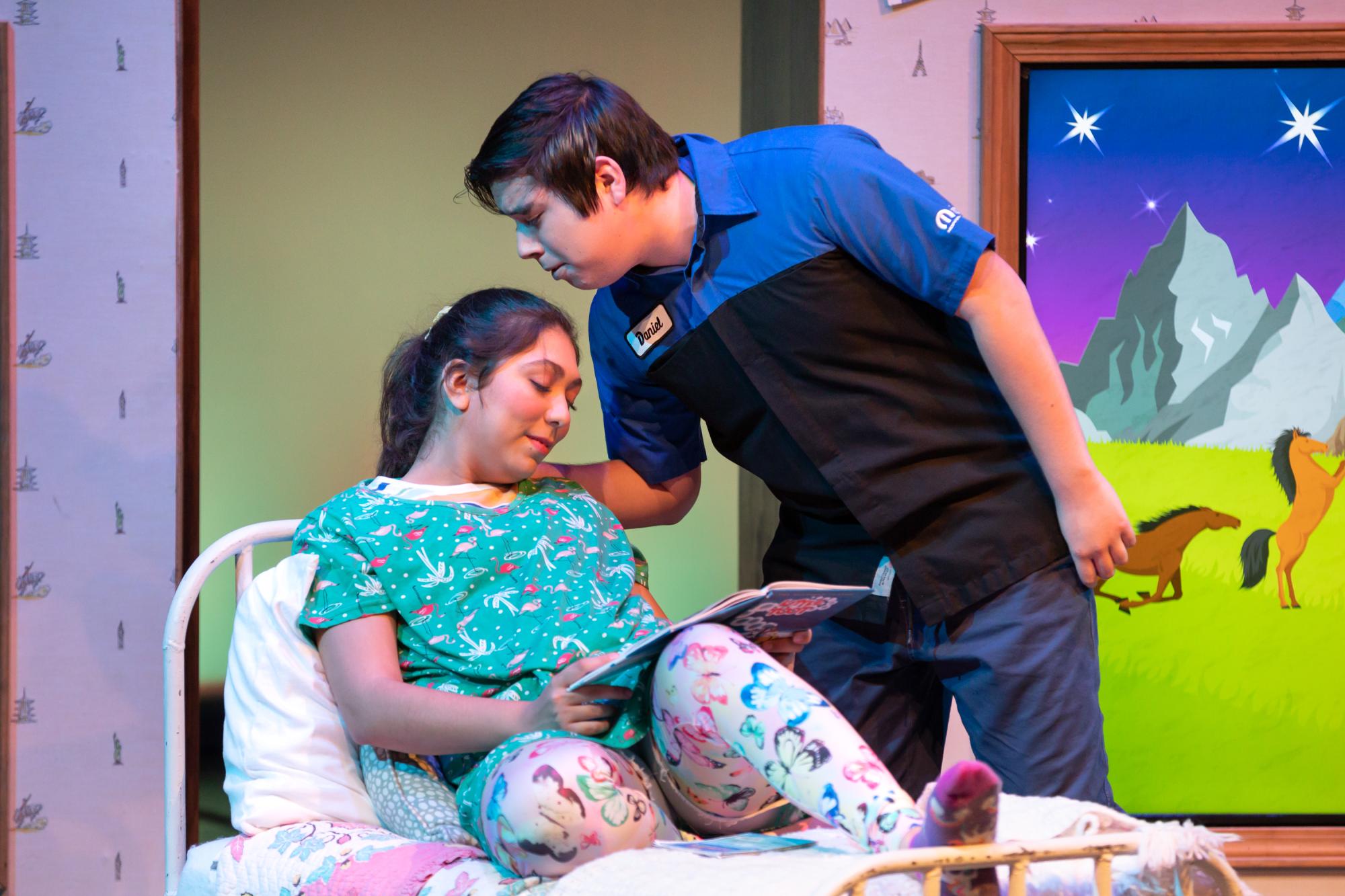 Lizzy Martinez, played by Katya Lopez, is kissed on her forehead goodnight while she reads a book by her Papi, played by Jose Calvillo