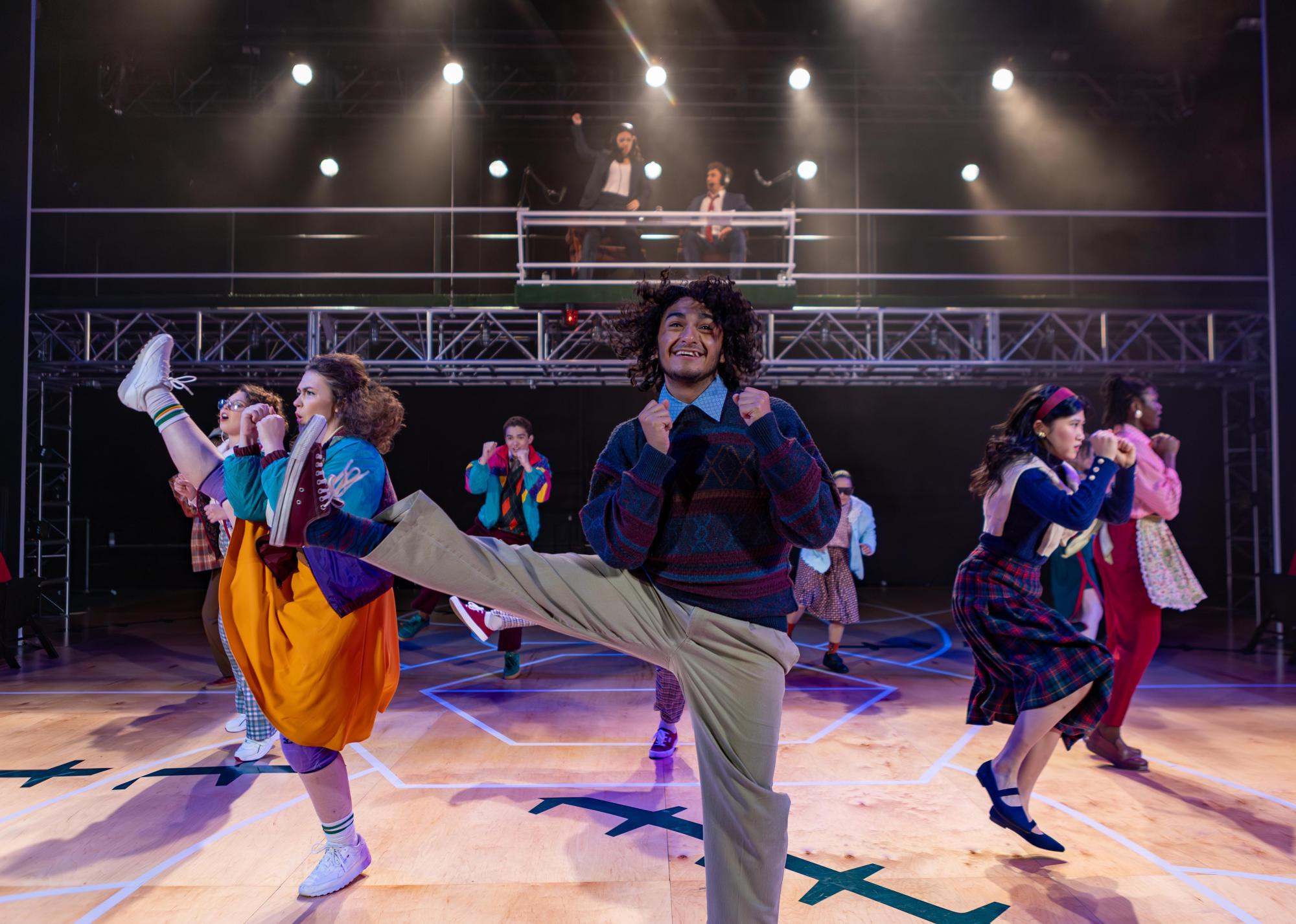 Legs in the air in high kicks, the cast of Great Lakes is pictured mid-jazzercise sequence