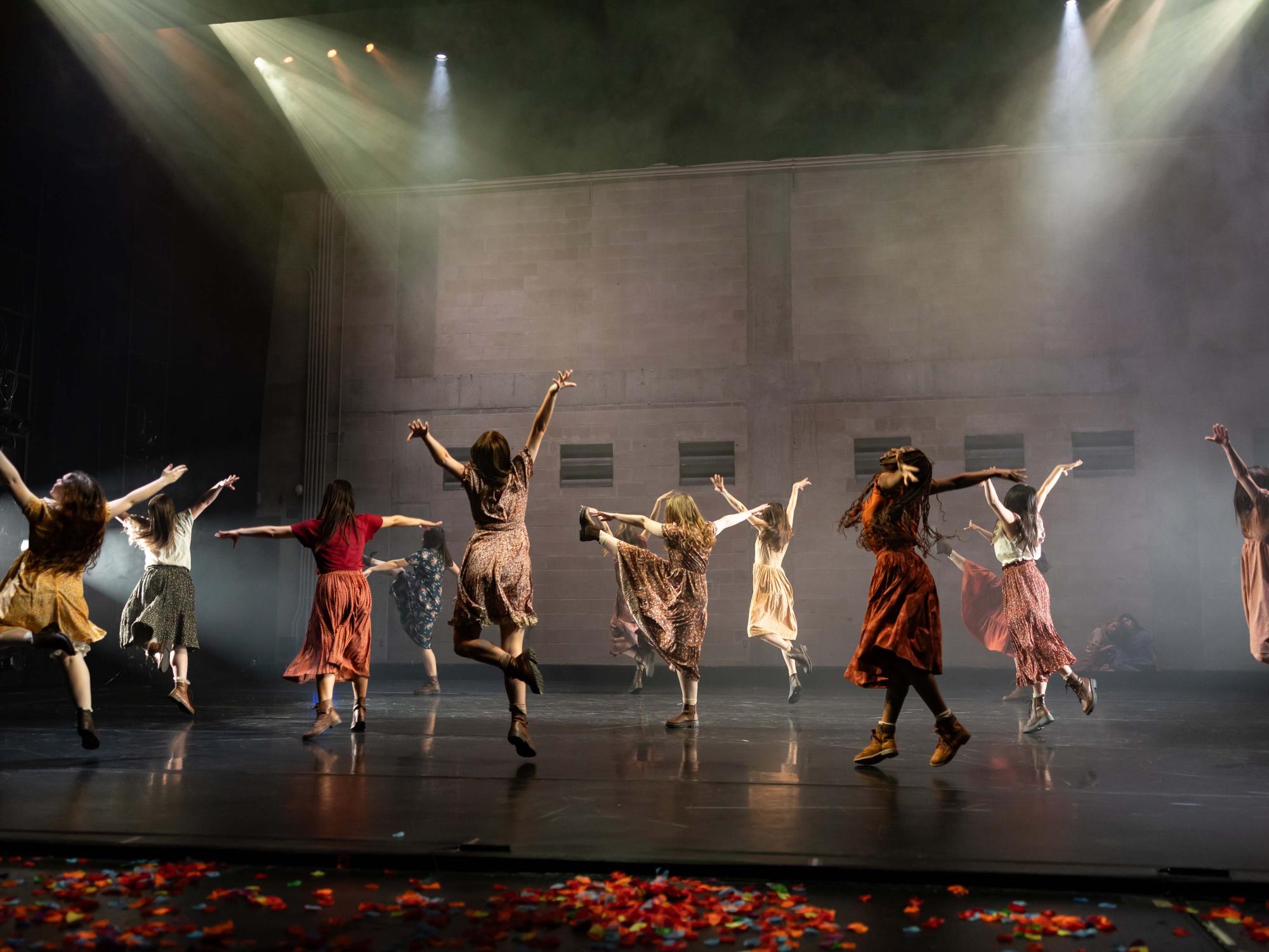 Dancers within Motherless Child fly in the air as they jump.